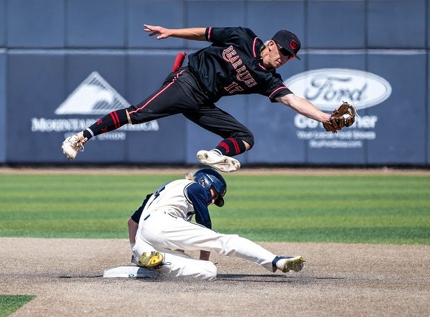 Bear River's Talon Marble catches an errant throw to second base while hurdling over Snow Canyon's Damon Ence. Snow Canyon would beat Bear River 3-2 in Utah baseball action. (Photo: Dave Argyle)
